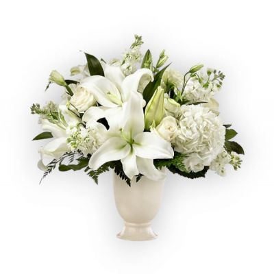 A stunning bouquet is a thoughtful way to send your condolences during difficult times. Each bouquet is handcrafted with lilies, hydrangeas and lisianthus to share your sympathy. While the lilies may initially arrive in bud form, they transform into bursting flowers as they open.