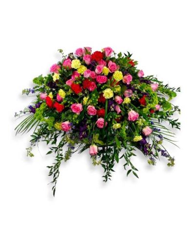 <p>A bright array of flowers combines to make a beautiful casket cover piece.</p>