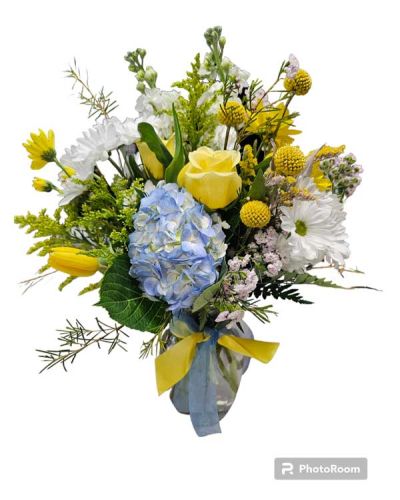 <p>This gorgeous creation with hues of the Amalfi coast, shades of blues and yellows.<br />
Florals can include, hydrangea,tulips, roses, daisies, stock, solidago, wax and assorted greens. Premium arrives blue glass keepsake vase. shown is deluxe<br />
This item is arranged professionally by our floral team and an original design of Bloomingdays.</p>